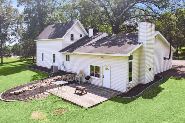 66578 330th St, Watkins, MN 55389 - back of house with a chimney, a deck, a lawn, and roof with shingles