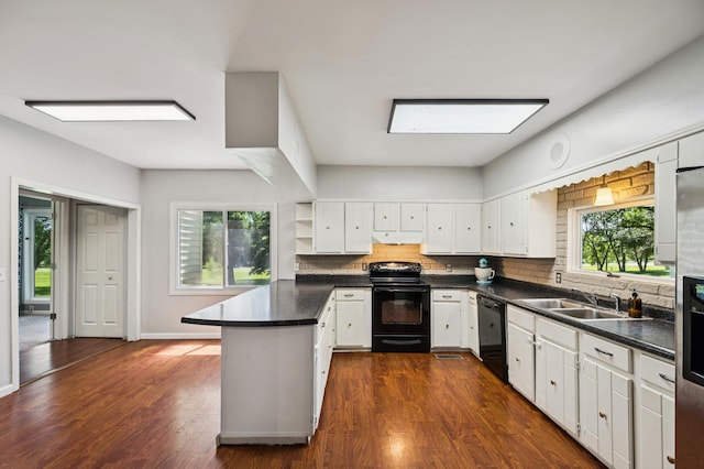 66578 330th St, Watkins, MN 55389 - kitchen featuring black appliances, a peninsula, dark countertops, under cabinet range hood, and tasteful backsplash