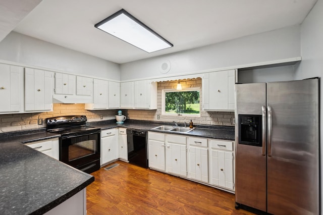 66578 330th St, Watkins, MN 55389 - kitchen featuring black appliances, under cabinet range hood, decorative backsplash, dark countertops, and white cabinets