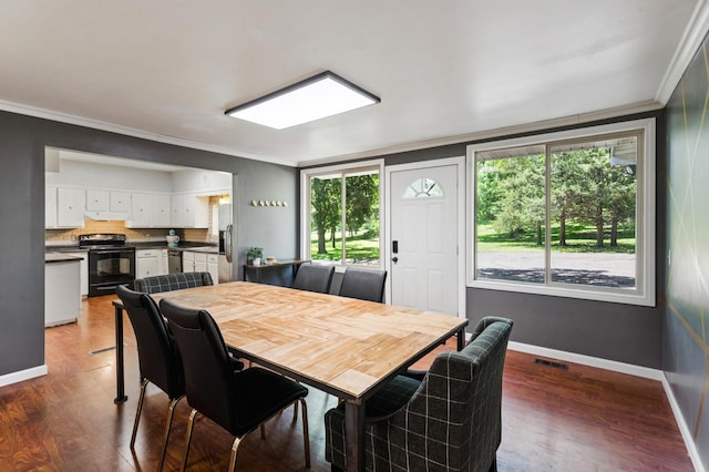 66578 330th St, Watkins, MN 55389 - dining space featuring healthy amount of natural light, wood finished floors, and ornamental molding
