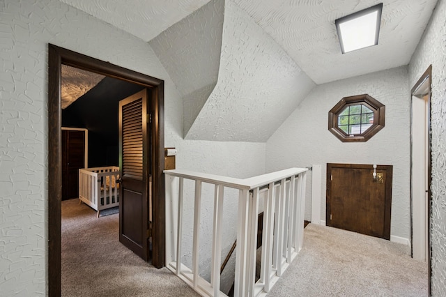 66578 330th St, Watkins, MN 55389 - hallway featuring an upstairs landing, vaulted ceiling, carpet floors, a textured wall, and a textured ceiling