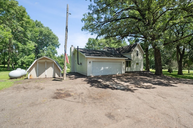 66578 330th St, Watkins, MN 55389 - garage featuring driveway and a storage shed