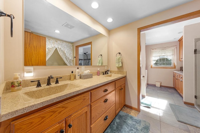 600 168th St, Summit Twp, MN 56026 - bathroom with double vanity, tile patterned flooring, recessed lighting, and a shower with door