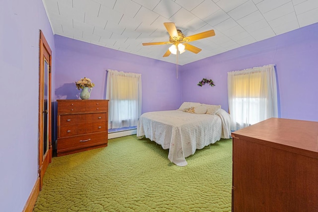 600 168th St, Summit Twp, MN 56026 - bedroom with a baseboard heating unit, carpet floors, and a ceiling fan