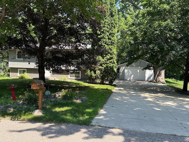 925 Holcombe Ave, Litchfield, MN 55355 - view of property hidden behind natural elements featuring a detached garage, an outbuilding, a front yard, and concrete driveway