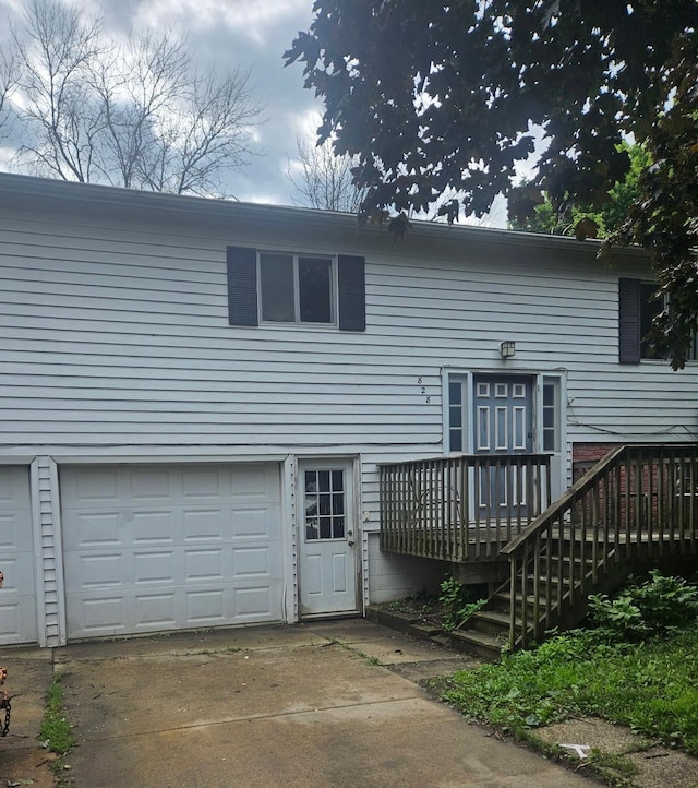 828 Center Ave S, Hayfield, MN 55940 - rear view of property with driveway, a deck, and an attached garage