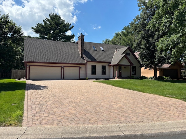 12310 Grouse St NW, Coon Rapids, MN 55448 - view of front of home with a garage and decorative driveway