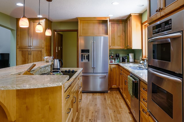 12310 Grouse St NW, Coon Rapids, MN 55448 - kitchen featuring appliances with stainless steel finishes, light countertops, light wood-style flooring, decorative light fixtures, and recessed lighting