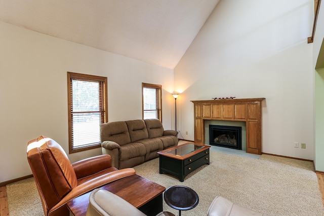 12310 Grouse St NW, Coon Rapids, MN 55448 - living area featuring high vaulted ceiling, a fireplace with flush hearth, and light carpet
