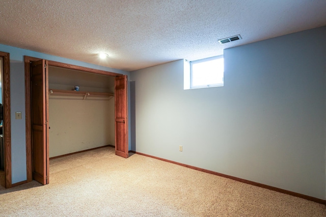 12310 Grouse St NW, Coon Rapids, MN 55448 - unfurnished bedroom with light carpet, a closet, and a textured ceiling