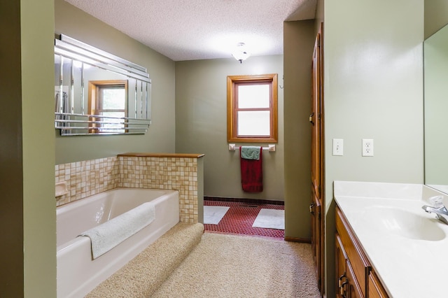 12310 Grouse St NW, Coon Rapids, MN 55448 - bathroom featuring vanity, a garden tub, and a textured ceiling