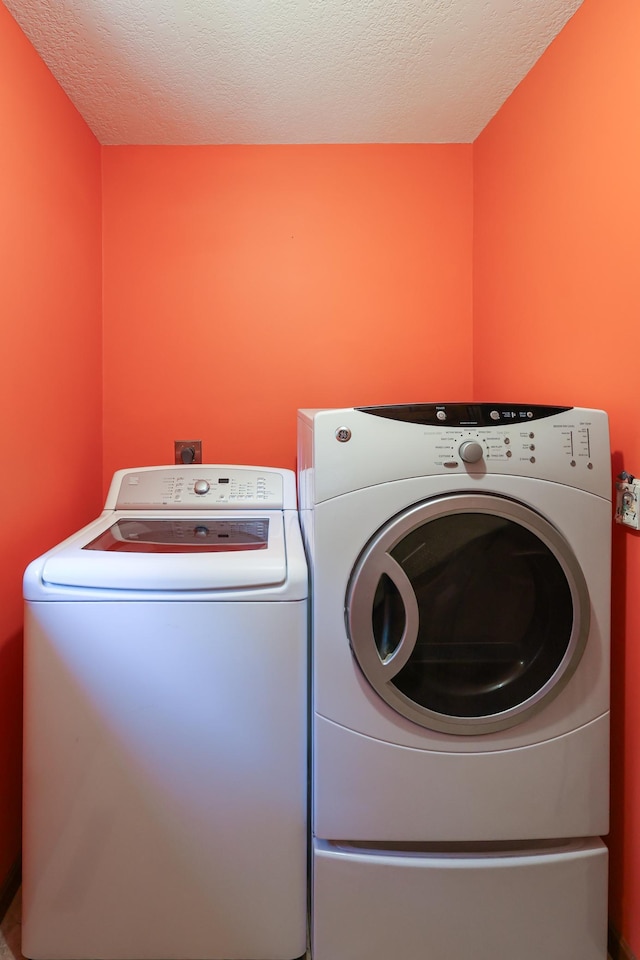 12310 Grouse St NW, Coon Rapids, MN 55448 - laundry area with separate washer and dryer and a textured ceiling