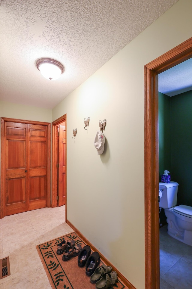 12310 Grouse St NW, Coon Rapids, MN 55448 - corridor featuring a textured ceiling and baseboards