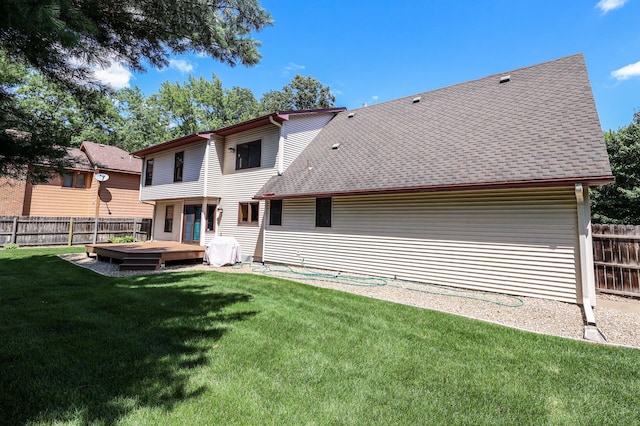 12310 Grouse St NW, Coon Rapids, MN 55448 - back of house with a fenced backyard, a wooden deck, and roof with shingles