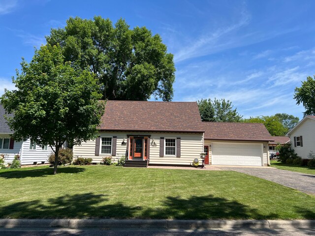 1010 Oakwood Ave, Benson, MN 56215 - single story home featuring driveway, an attached garage, a front lawn, and a shingled roof