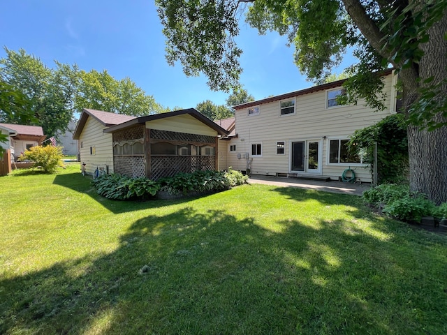 1010 Oakwood Ave, Benson, MN 56215 - rear view of property featuring a yard and a patio