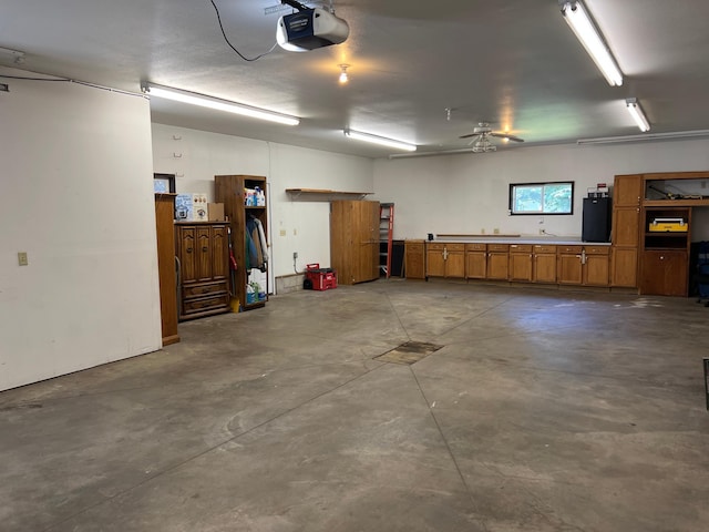 1010 Oakwood Ave, Benson, MN 56215 - garage featuring a garage door opener and a ceiling fan