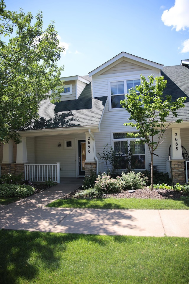 2690 Pinkspire Ln E, Maplewood, MN 55119 - view of front of home with roof with shingles, a porch, and stone siding