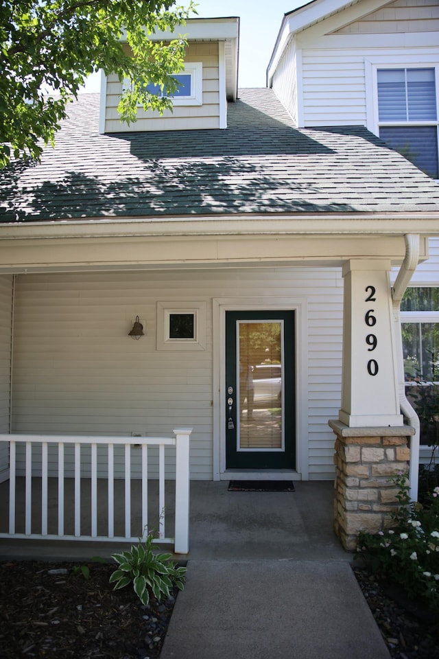 2690 Pinkspire Ln E, Maplewood, MN 55119 - doorway to property with a shingled roof and covered porch