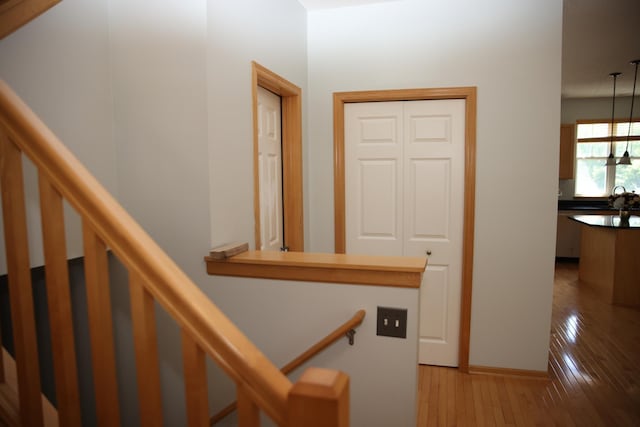 2690 Pinkspire Ln E, Maplewood, MN 55119 - stairs featuring hardwood / wood-style flooring and baseboards