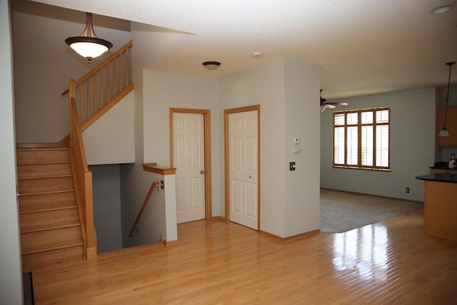 2690 Pinkspire Ln E, Maplewood, MN 55119 - stairway featuring wood finished floors and a ceiling fan