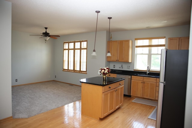 2690 Pinkspire Ln E, Maplewood, MN 55119 - kitchen featuring appliances with stainless steel finishes, a center island, light wood finished floors, and a ceiling fan