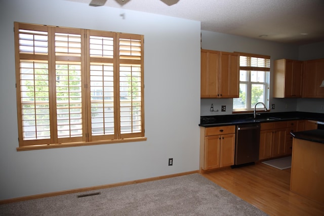 2690 Pinkspire Ln E, Maplewood, MN 55119 - kitchen featuring stainless steel dishwasher, dark countertops, ceiling fan, light wood-style flooring, and light brown cabinetry