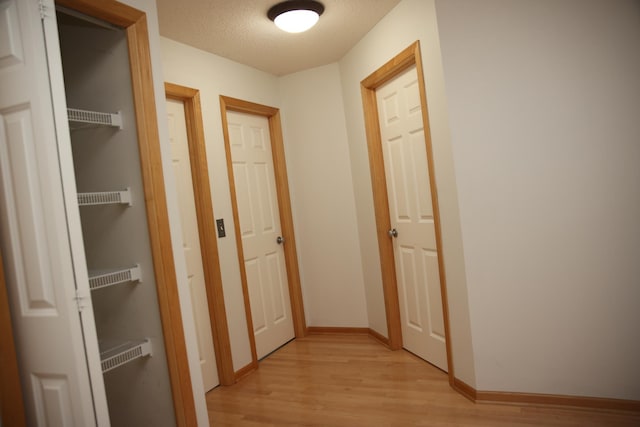 2690 Pinkspire Ln E, Maplewood, MN 55119 - hall with light wood-type flooring and a textured ceiling