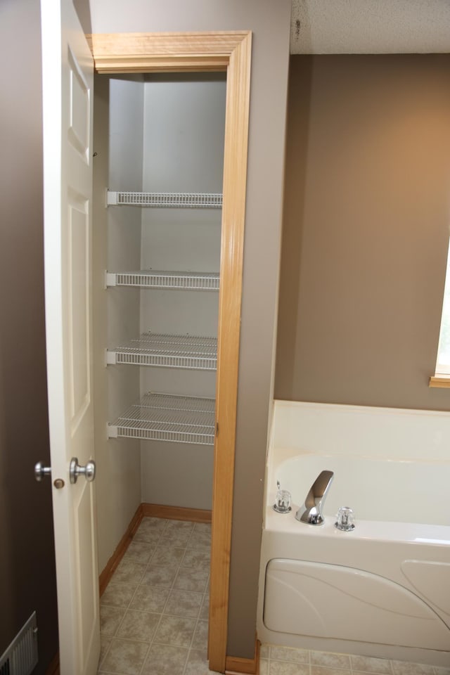 2690 Pinkspire Ln E, Maplewood, MN 55119 - full bath featuring a garden tub and tile patterned flooring