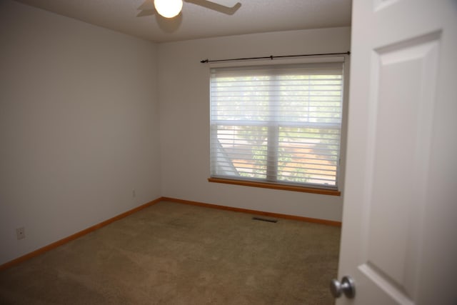 2690 Pinkspire Ln E, Maplewood, MN 55119 - carpeted empty room featuring ceiling fan and healthy amount of natural light