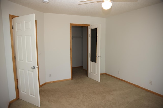 2690 Pinkspire Ln E, Maplewood, MN 55119 - unfurnished bedroom featuring light carpet, a spacious closet, a ceiling fan, and a textured ceiling