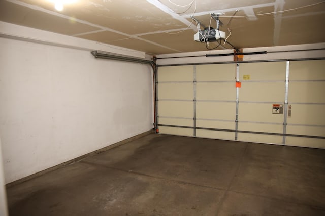 2690 Pinkspire Ln E, Maplewood, MN 55119 - garage featuring a garage door opener and baseboards