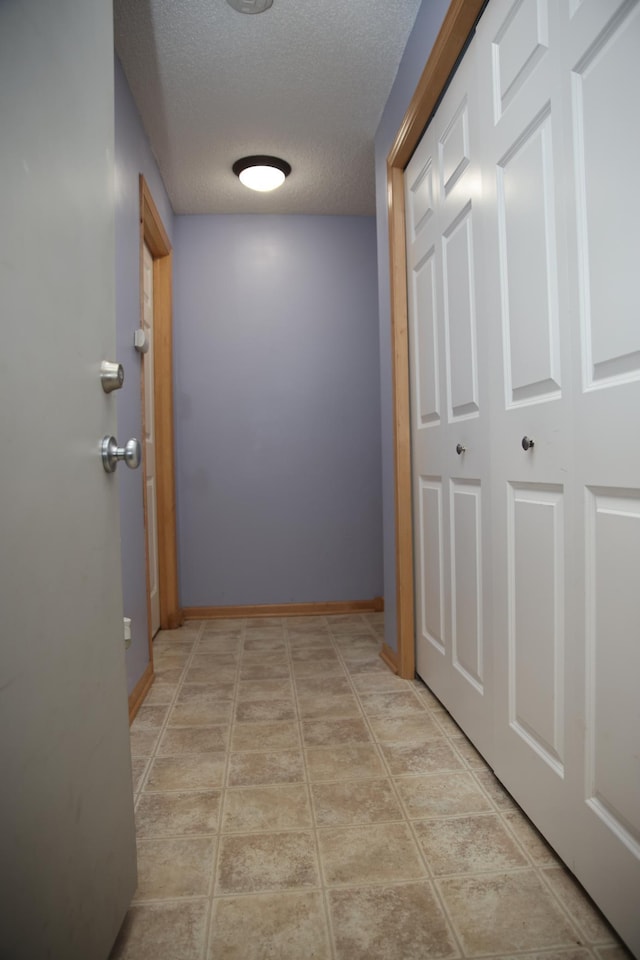 2690 Pinkspire Ln E, Maplewood, MN 55119 - hall featuring a textured ceiling and baseboards