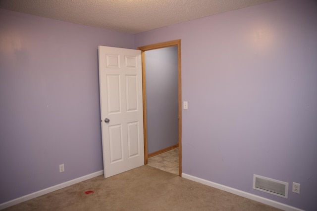 2690 Pinkspire Ln E, Maplewood, MN 55119 - carpeted empty room featuring baseboards and a textured ceiling