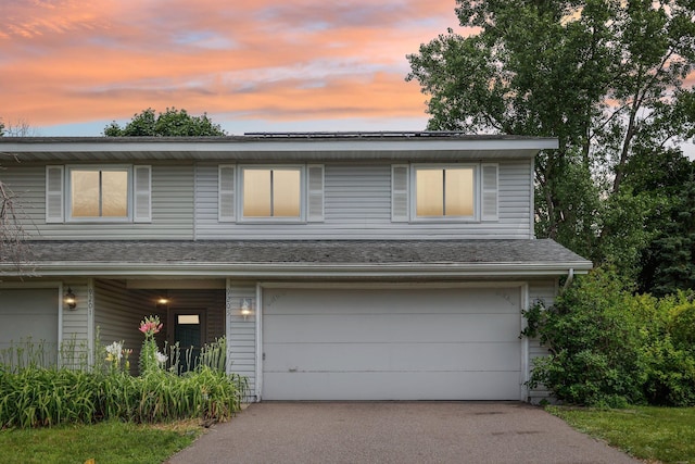 9205 29th Ave N, New Hope, MN 55427 - view of front facade featuring a garage, driveway, and solar panels