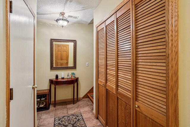 9205 29th Ave N, New Hope, MN 55427 - hall with light tile patterned floors and a textured ceiling