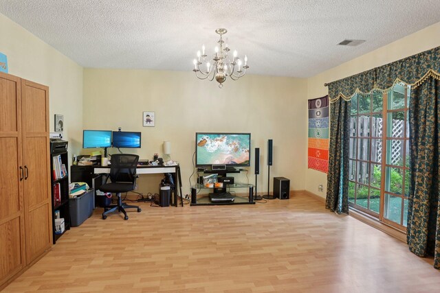 9205 29th Ave N, New Hope, MN 55427 - office area featuring light wood-type flooring, a chandelier, and a textured ceiling