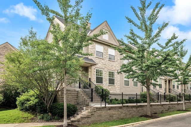 8291 Labont Way, Eden Prairie, MN 55344 - view of front of home with stone siding, stairway, and a chimney