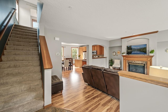 8291 Labont Way, Eden Prairie, MN 55344 - living room featuring stairway, light wood-style floors, and a fireplace