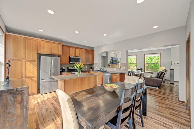 8291 Labont Way, Eden Prairie, MN 55344 - kitchen with stainless steel appliances, light wood-type flooring, tasteful backsplash, recessed lighting, and a kitchen island