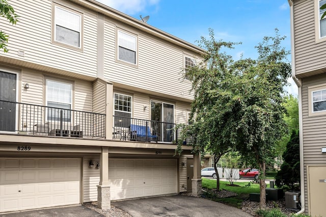 8291 Labont Way, Eden Prairie, MN 55344 - rear view of property with asphalt driveway, a garage, and a balcony