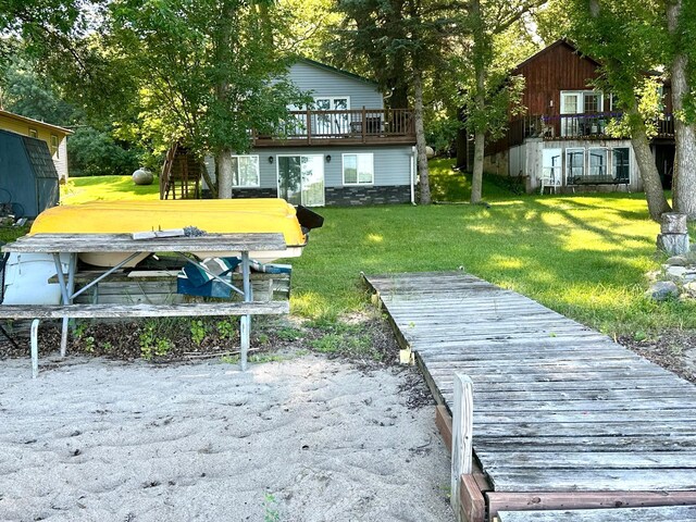 10285 237th Ave, Spirit Lake, IA 51360 - back of house with a yard and a wooden deck