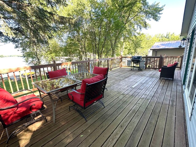 10285 237th Ave, Spirit Lake, IA 51360 - wooden deck featuring outdoor dining area and area for grilling