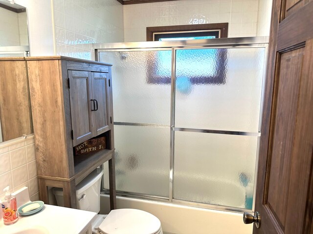 10285 237th Ave, Spirit Lake, IA 51360 - full bath featuring tile walls, vanity, and enclosed tub / shower combo