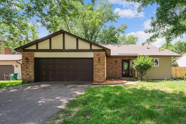 8341 Abbott Ave N, Brooklyn Park, MN 55443 - view of front of property with an attached garage, brick siding, driveway, and a shingled roof