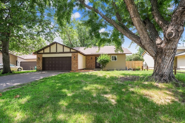 8341 Abbott Ave N, Brooklyn Park, MN 55443 - view of front facade with driveway, brick siding, and an attached garage