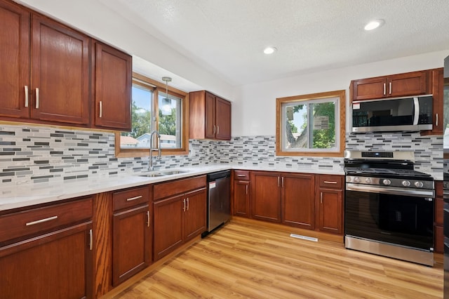 8341 Abbott Ave N, Brooklyn Park, MN 55443 - kitchen with appliances with stainless steel finishes, light countertops, light wood finished floors, healthy amount of natural light, and recessed lighting