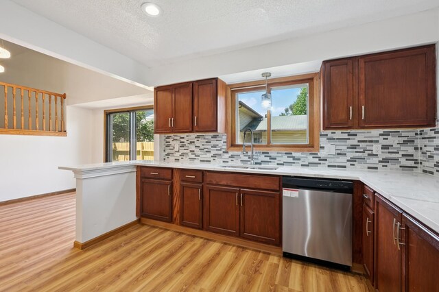 8341 Abbott Ave N, Brooklyn Park, MN 55443 - kitchen with dishwasher, light wood-style floors, decorative backsplash, and a textured ceiling