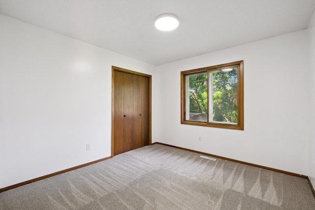 8341 Abbott Ave N, Brooklyn Park, MN 55443 - unfurnished bedroom with carpet and a closet