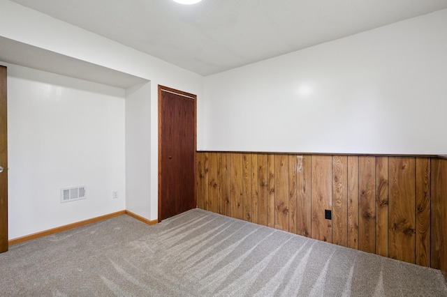 8341 Abbott Ave N, Brooklyn Park, MN 55443 - carpeted spare room featuring wooden walls and baseboards